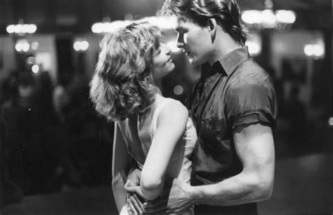 black and white photograph of a man kissing a woman's forehead on the ...