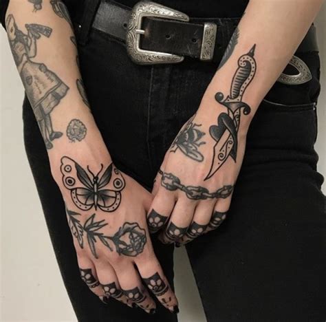 Black traditional tattoos on the both hands - Tattoogrid.net