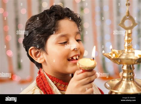 Boy burning oil lamps on Diwali Stock Photo - Alamy