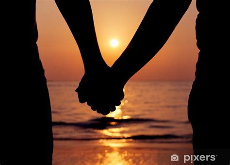 Wall Mural Silhouettes couples holding hands on sunset. - PIXERS.CO.NZ