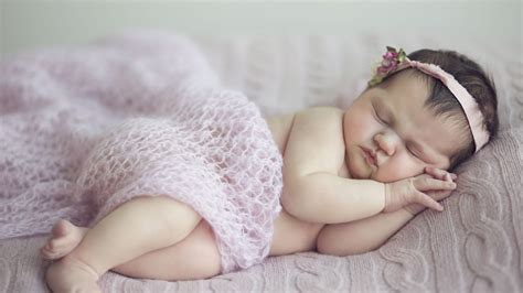 cute baby girl is sleeping on bed covered with netted cloth and having band on head hd cute ...