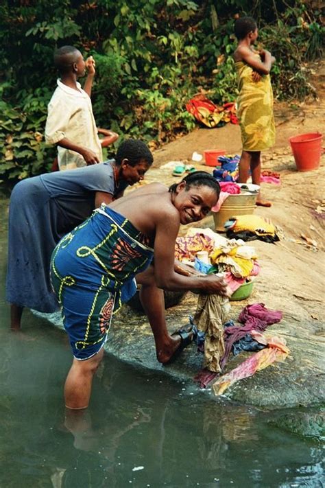 Everyday life in Gabon as the women of this tribe wash their clothes on the river basin ...