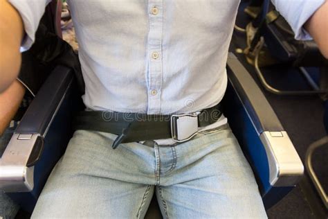 Male Passenger with Seat Belt Fastened while Sitting on Airplane for Safe Flight. Stock Photo ...