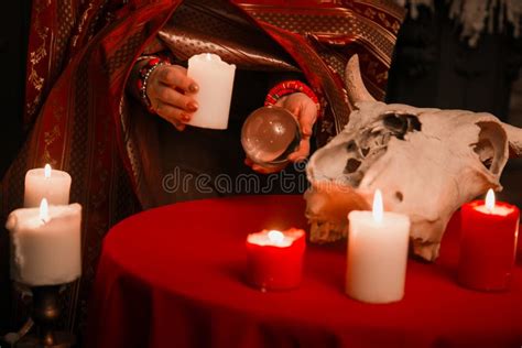 A Woman Holds A Candle To Perform A Magical Ritual. The Witch Casts A Spell Stock Image - Image ...