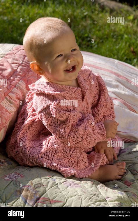 Baby girl smiling and laughing outside in the garden Stock Photo - Alamy