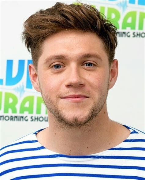 a close up of a person wearing a striped shirt