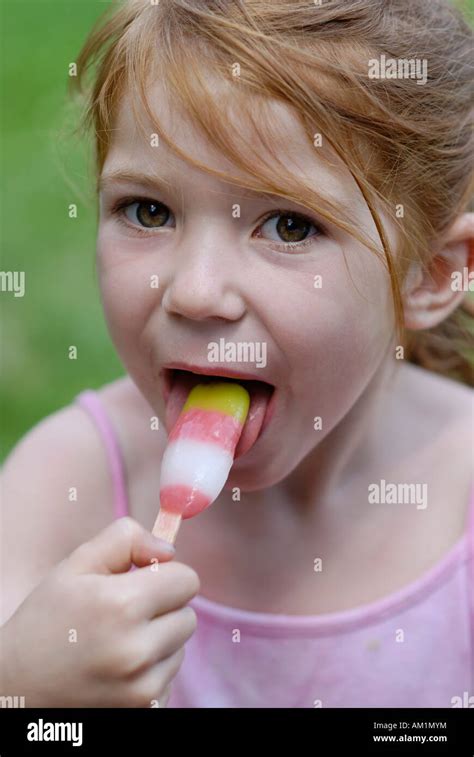 Little girl eating ice cream iced lolly Stock Photo - Alamy