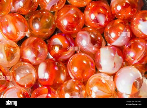 Orange, white, and transparent swirl glass marbles Stock Photo - Alamy