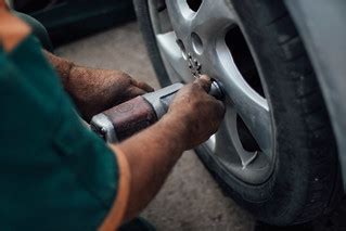 Tyre technician working with a compressed air impact wrenc… | Flickr