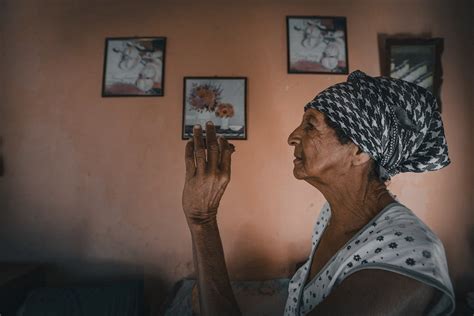 Elderly ethnic woman with raised arm in old house · Free Stock Photo