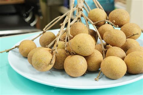 Premium Photo | Sweet fruit a bunch of longan on a plate longan ...