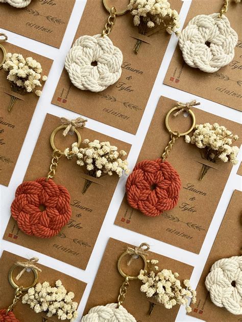 many different types of crochet keychains are displayed on brown cards ...