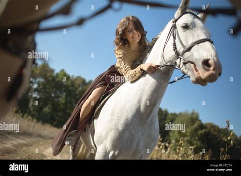 Beautiful girl riding a horse Stock Photo - Alamy