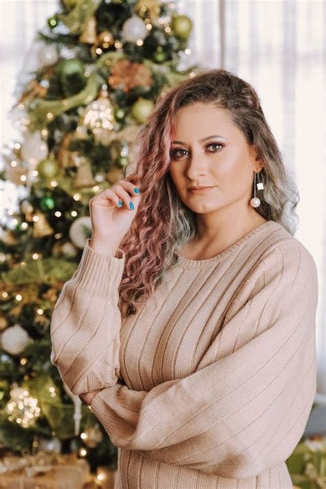 Portrait of a Woman in Front of a Christmas Tree · Free Stock Photo