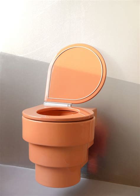 an orange toilet with the lid up
