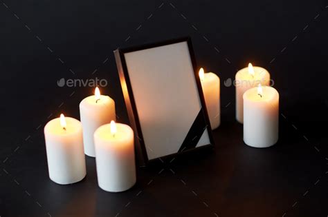 black ribbon on photo frame and candles at funeral - Stock Image - Everypixel