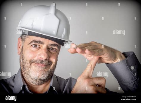 Construction worker makes a sign of downtime and rest Stock Photo - Alamy