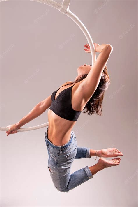 Premium Photo | A female aerial hoop gymnast performing exercises on an aerial hoop