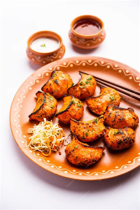Free Photo | Tandoori momo, veg or non veg in red and cream sauce, served with sauce. nepal and ...
