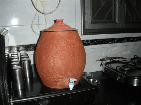 a large brown vase sitting on top of a stove
