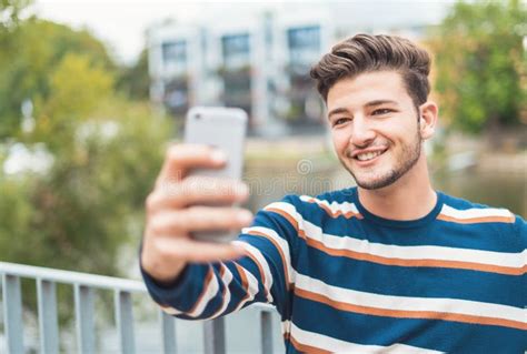 Cheerful Young Man Smiling and Taking Selfies while Enjoying Stock Image - Image of happy ...