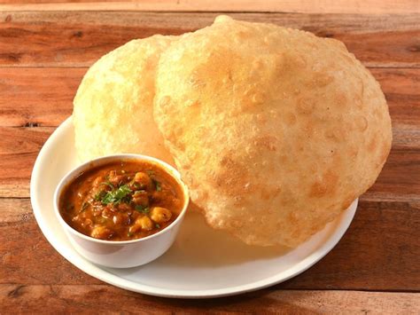 Premium Photo | Chole Bhature spicy Chick Peas curry also known as Chole or Channa Masala is ...