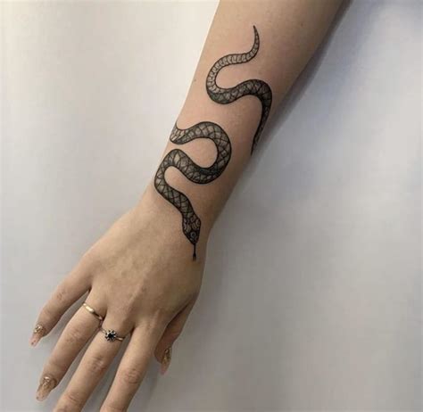 snake tattoo designs on wrist - Eboni Murrell