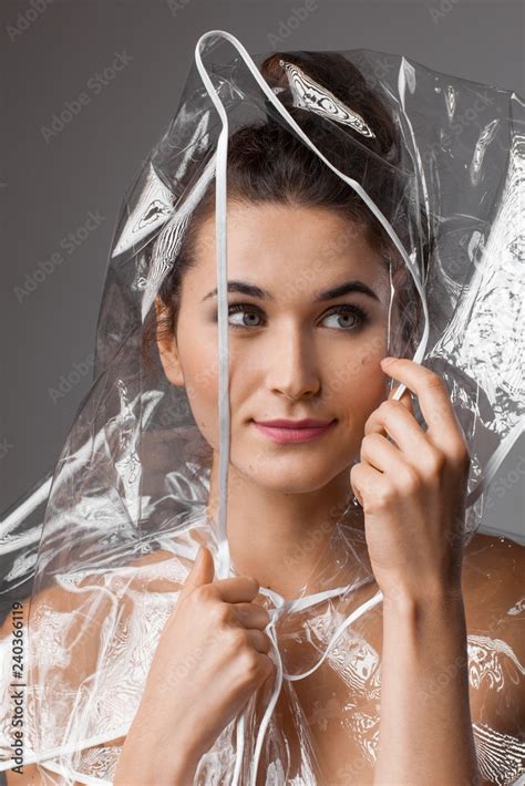 Beautiful woman in a transparent rain coat Stock Photo | Adobe Stock