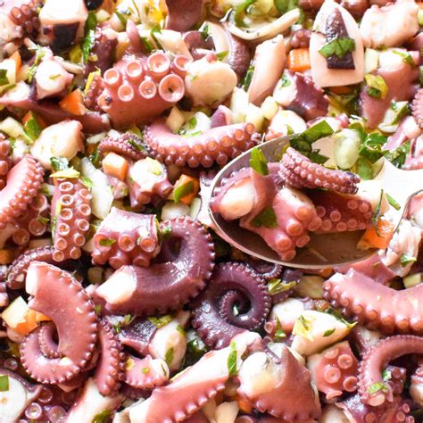 an octopus salad is being served with a spoon
