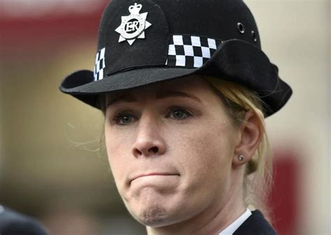 a woman wearing a police hat looking at the camera