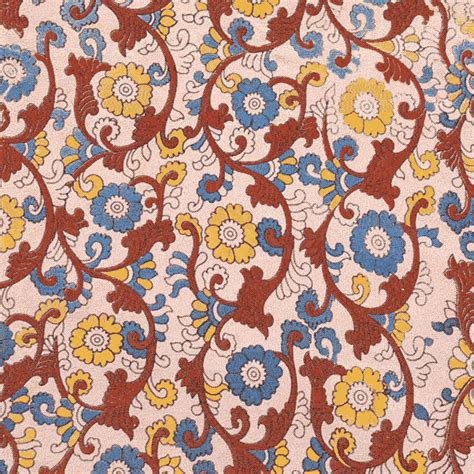 an orange, yellow and blue floral pattern on fabric