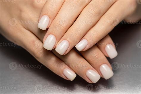 Beautiful nude manicure. Short square nails. Nail design. Manicure with gel polish. Close-up of ...