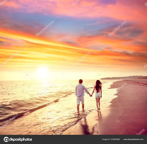 Young Couple Walking Beach Sunset Stock Photo by ©tomwang 375624682