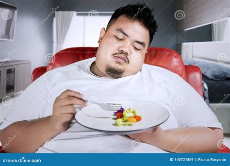 Sad Obese Man Eats Salad in the Bedroom Stock Image - Image of obese ...