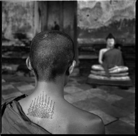 Young Thai Monk with Buddhist tattoos, meditating by Chris Rainier ...