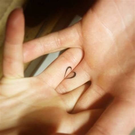 Matching half a heart tattooed on the finer | www.otziapp.com | Couple tattoos, Matching couple ...