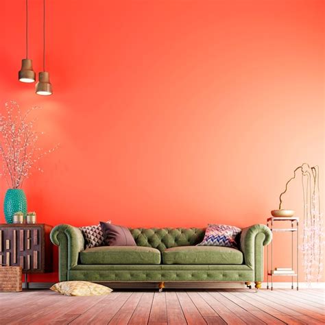 Premium Photo | Green sofa on a living coral color wall in a minimalist living room with classic ...