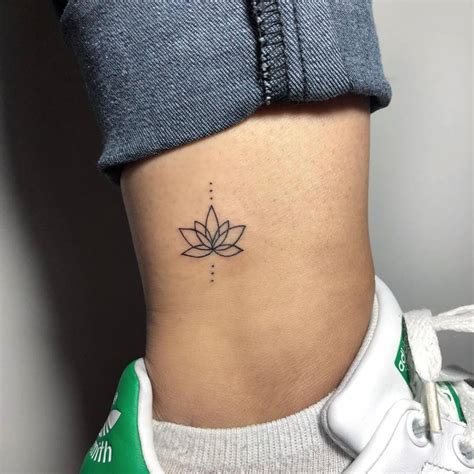 Minimalist lotus flower tattoo on the ankle