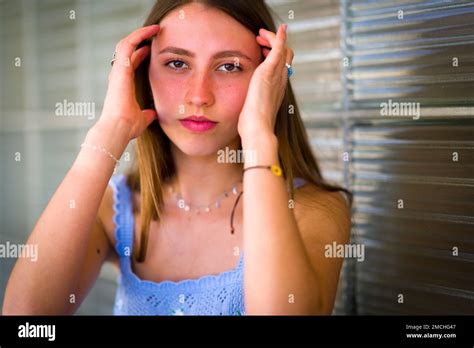 Close up Portrait of Teenage Girl Leaning Against Art Deco Glass Brick Window Stock Photo - Alamy