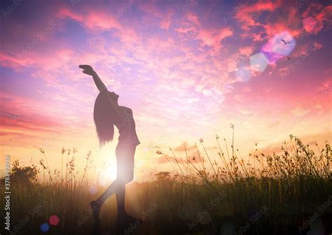 Celebration of life day concept: Silhouette of healthy woman raised hands for praise and worship ...