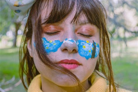 Teen girl with colorful painting on face · Free Stock Photo