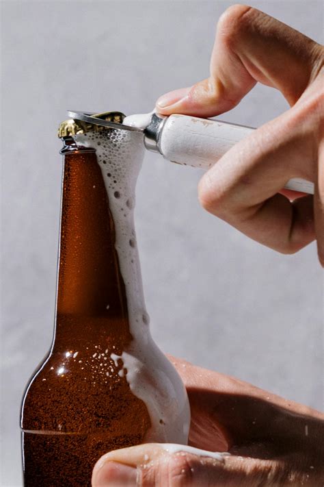 Person Holding Brown Glass Bottle · Free Stock Photo