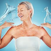 Water splash, senior and happy woman smile happy about wellness, skincare and healthy skin ...