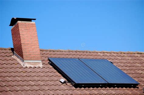 Red roof with solar panels stock image. Image of installation - 6648791