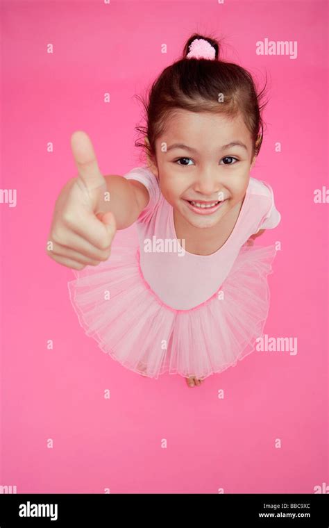 Young girl in ballet outfit, giving thumbs up sign Stock Photo - Alamy