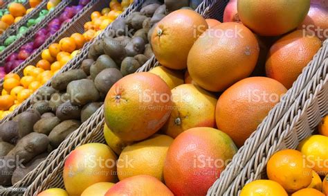 Assorted Tropical Fruit Baskets In A Grocery Store Pile Of Grapefruits For Selling Mix Of Fruits ...