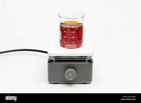 Beaker of liquid chemical being heated on a hot plate Stock Photo - Alamy