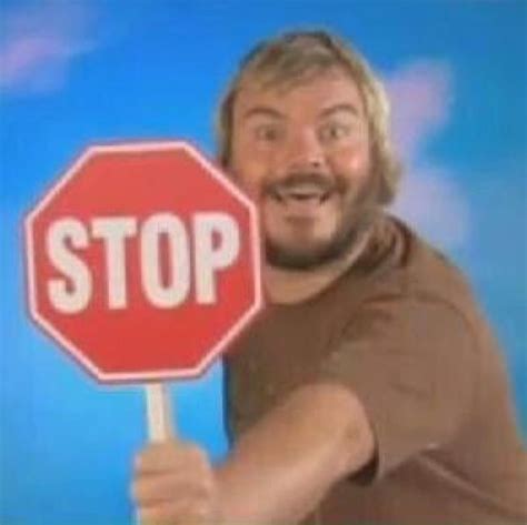 a man holding a stop sign in front of a tv screen with the caption that says stop