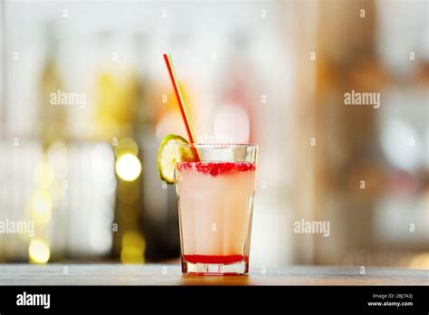 Glass of cocktail on bar background Stock Photo - Alamy