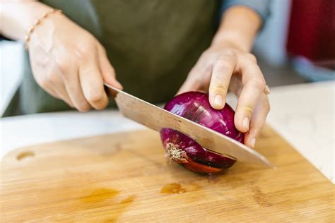 Woman Cutting Onion with Knife · Free Stock Photo